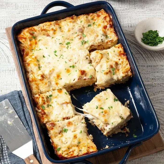 An alfredo lasagna in a rectangle dish for Thanksgiving dinner. An alfredo lasagna in a rectangle dish for Thanksgiving dinner.