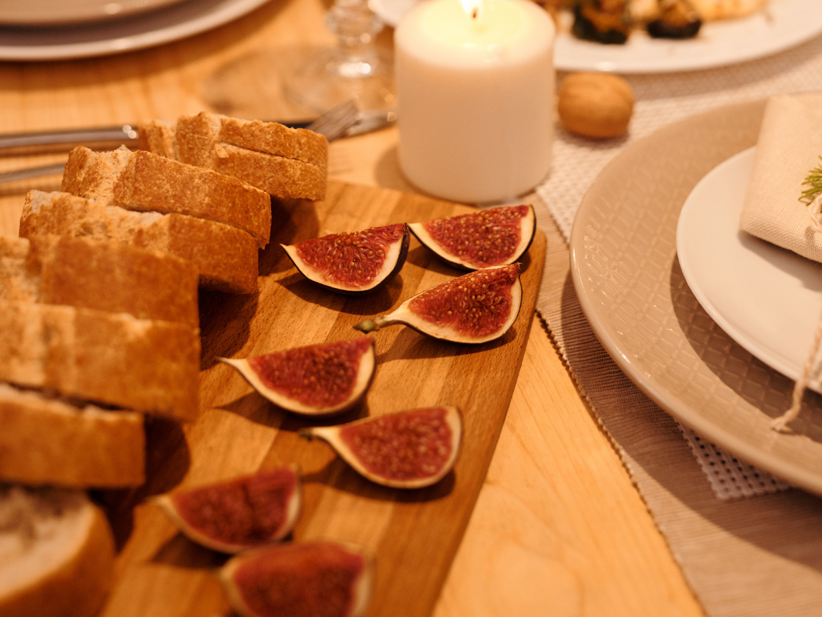 Slices of bread and figs on a wooden cutting board