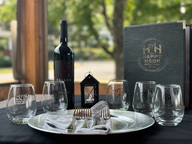 A bottle of wine is sitting on a table next to a menu.
