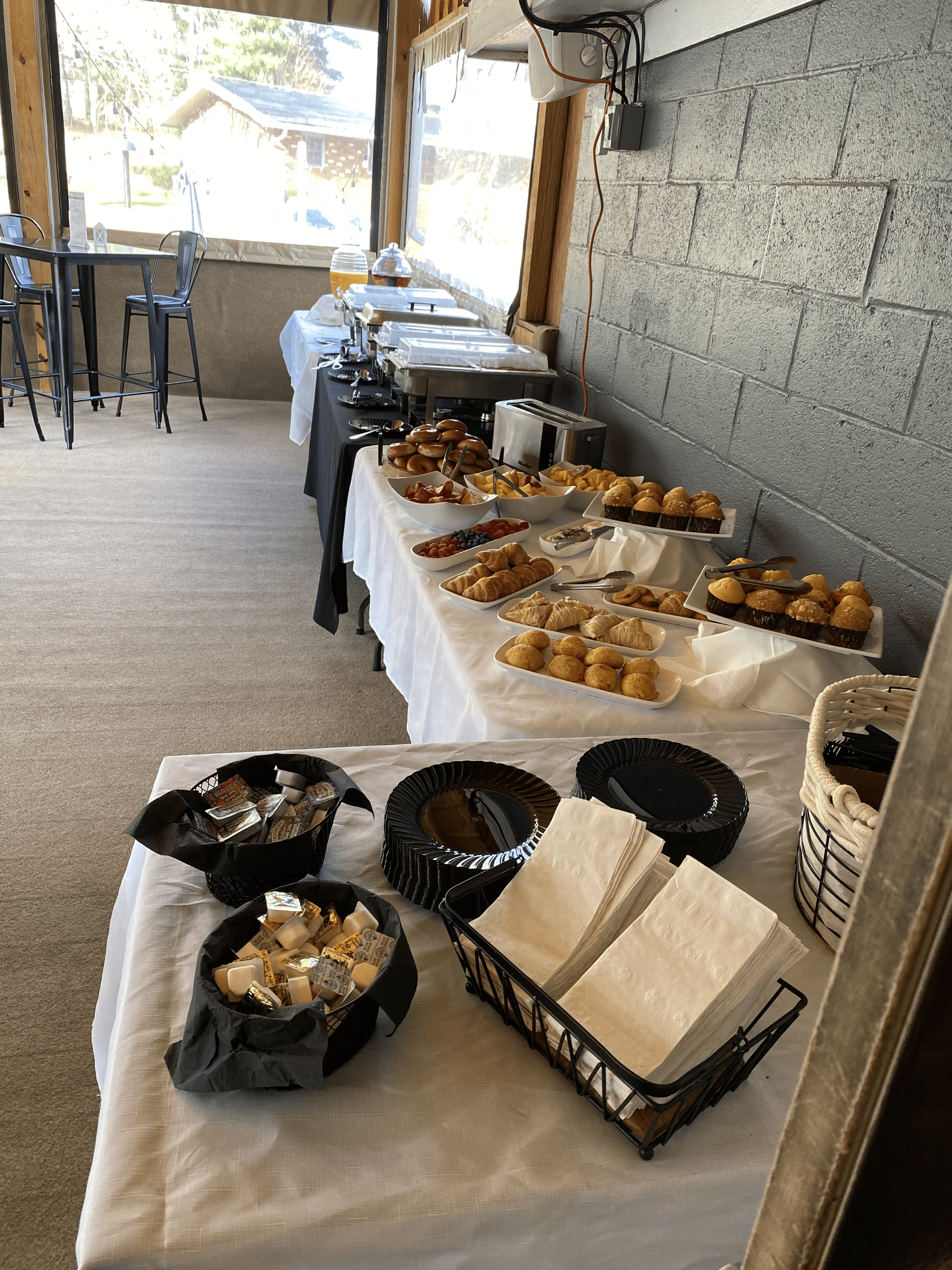 A buffet table with a variety of food on it in a room at Happy Hour Bar & Grill