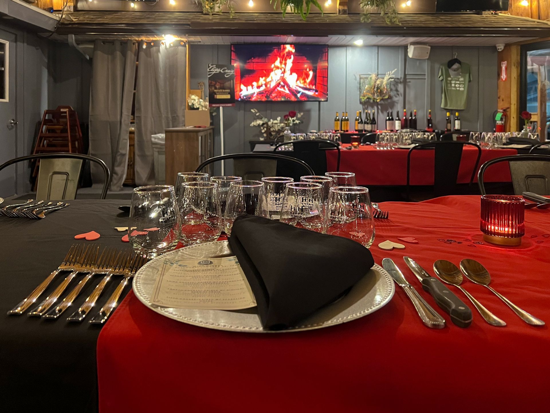 A table set for a dinner party with plates , silverware , and glasses.