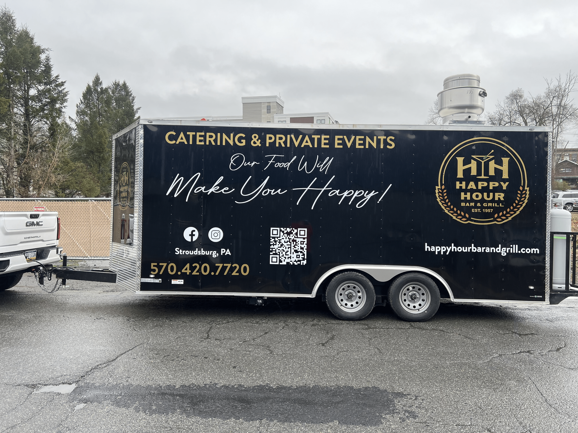 Happy Hour Bar & Grill food truck for catering and private events is parked in a parking lot.