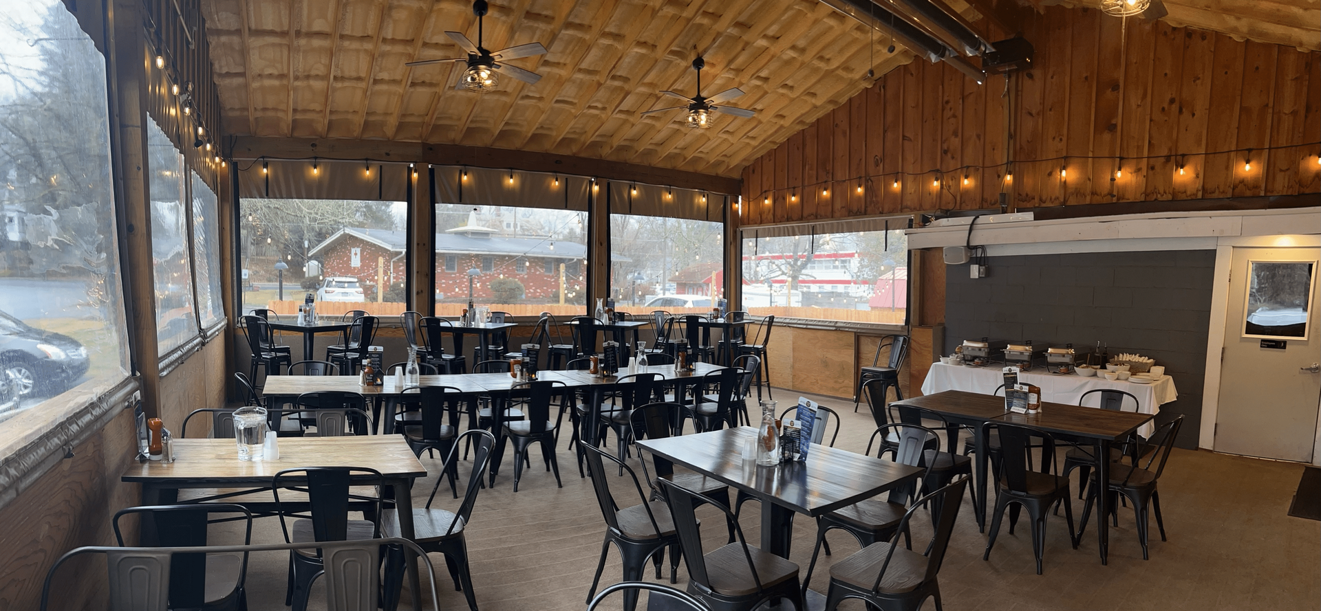 A large room filled with tables and chairs in a restaurant at Happy Hour Bar & Grill