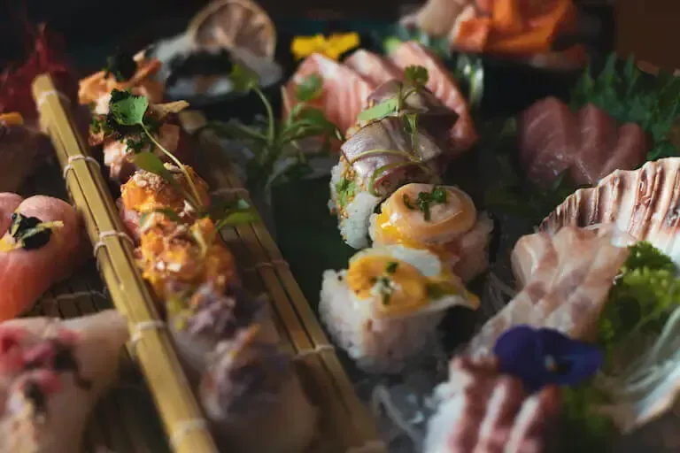 A close up of a plate of sushi on a table.
