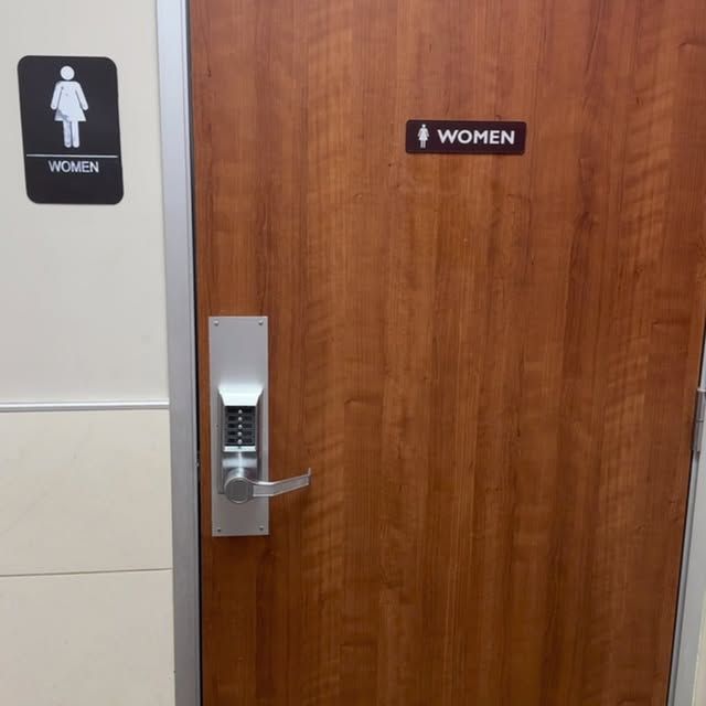 A wooden door with a sign on it that says women