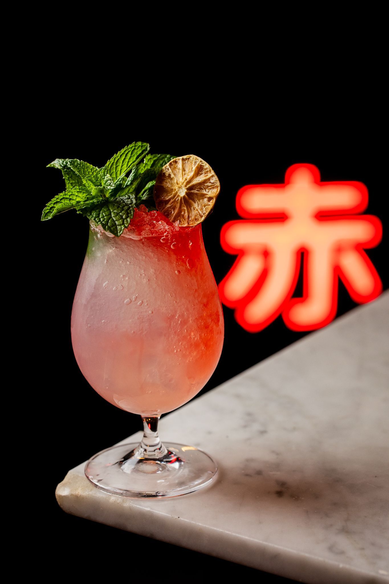 A close up of a cocktail in a martini glass on a table.