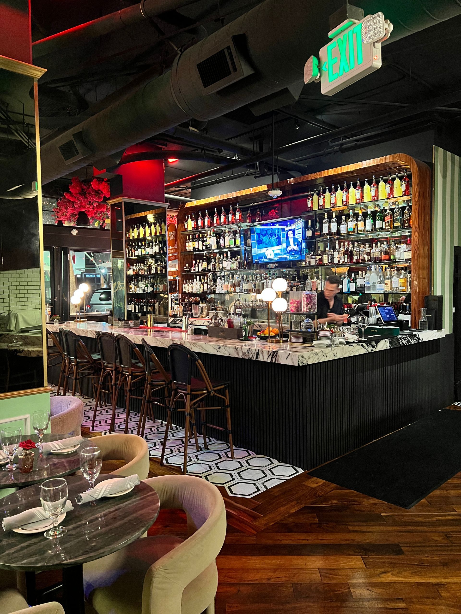 A restaurant with tables and chairs and a wall of cheese