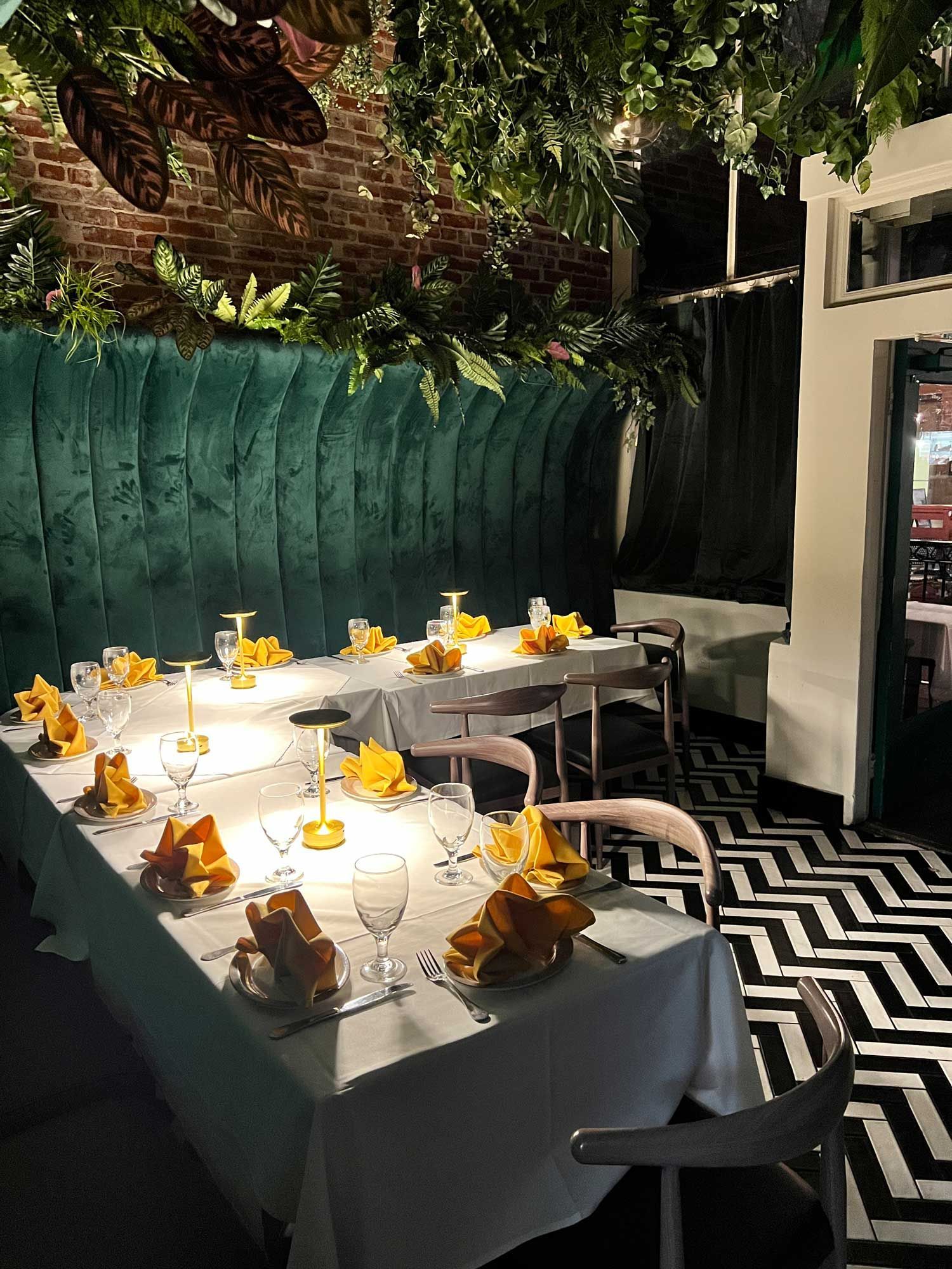 A restaurant with tables and chairs and a mural on the wall.
