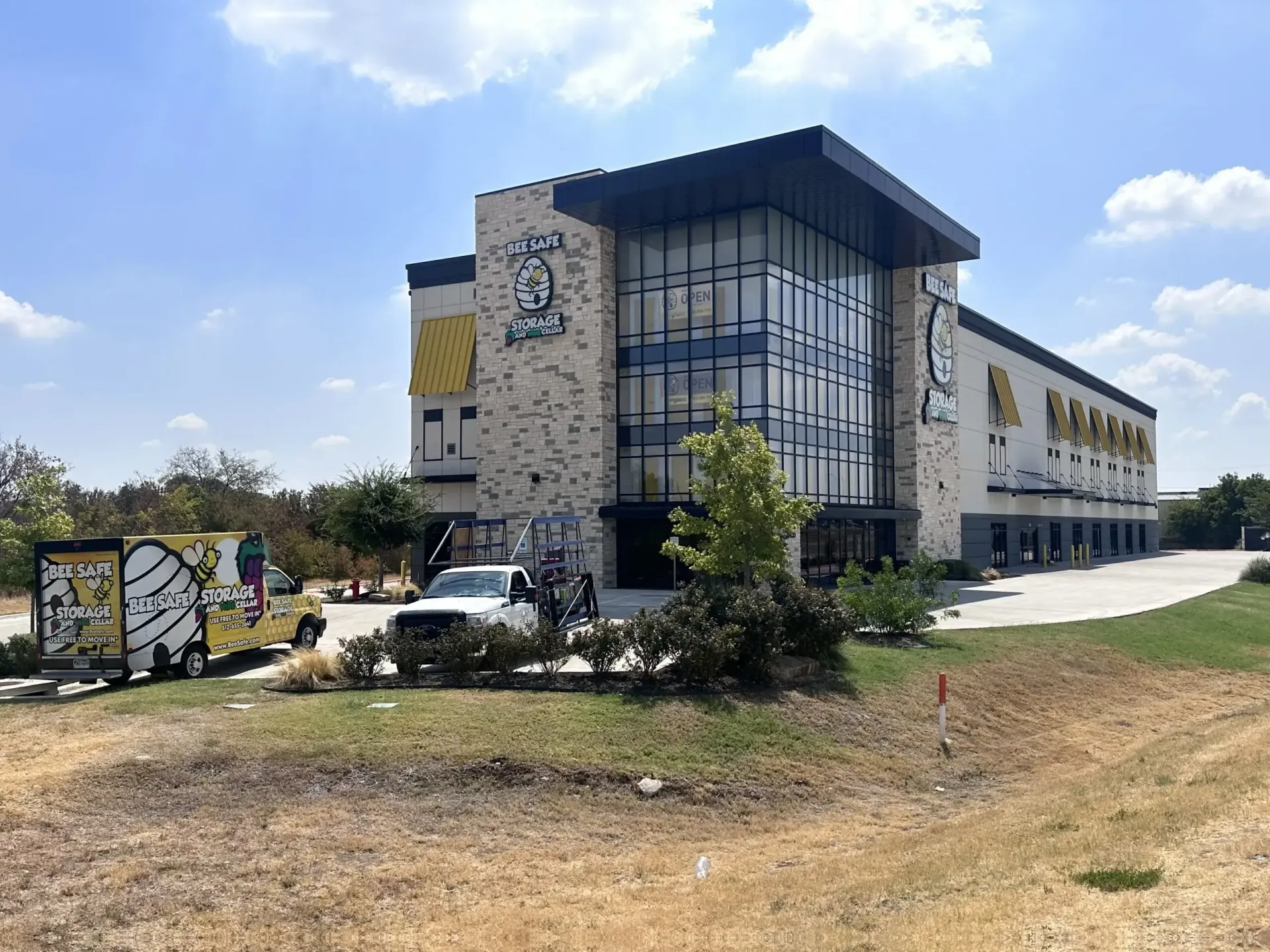 A large building with a lot of windows and a truck parked in front of it.