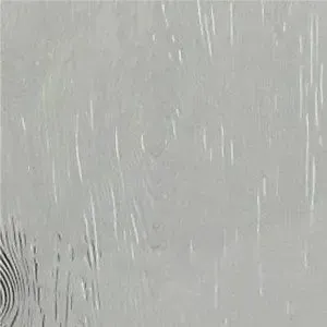 A close up of a piece of glass with a grainy texture.