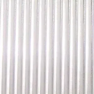 A close up of a white corrugated metal wall.