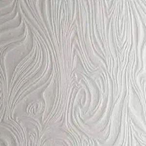 A close up of a white wall with a pattern on it.