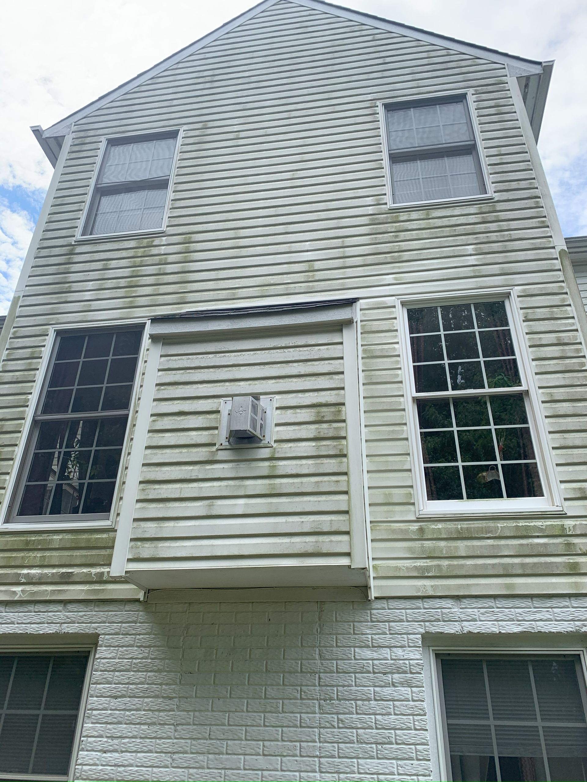 The front of a house with a lot of windows and siding.