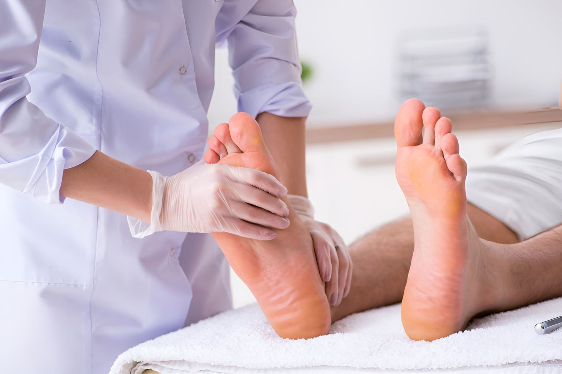 A Nurse Is Examining A Patient's Foot In A Hospital — Hastings Podiatry Centre In Port Macquarie, NSW