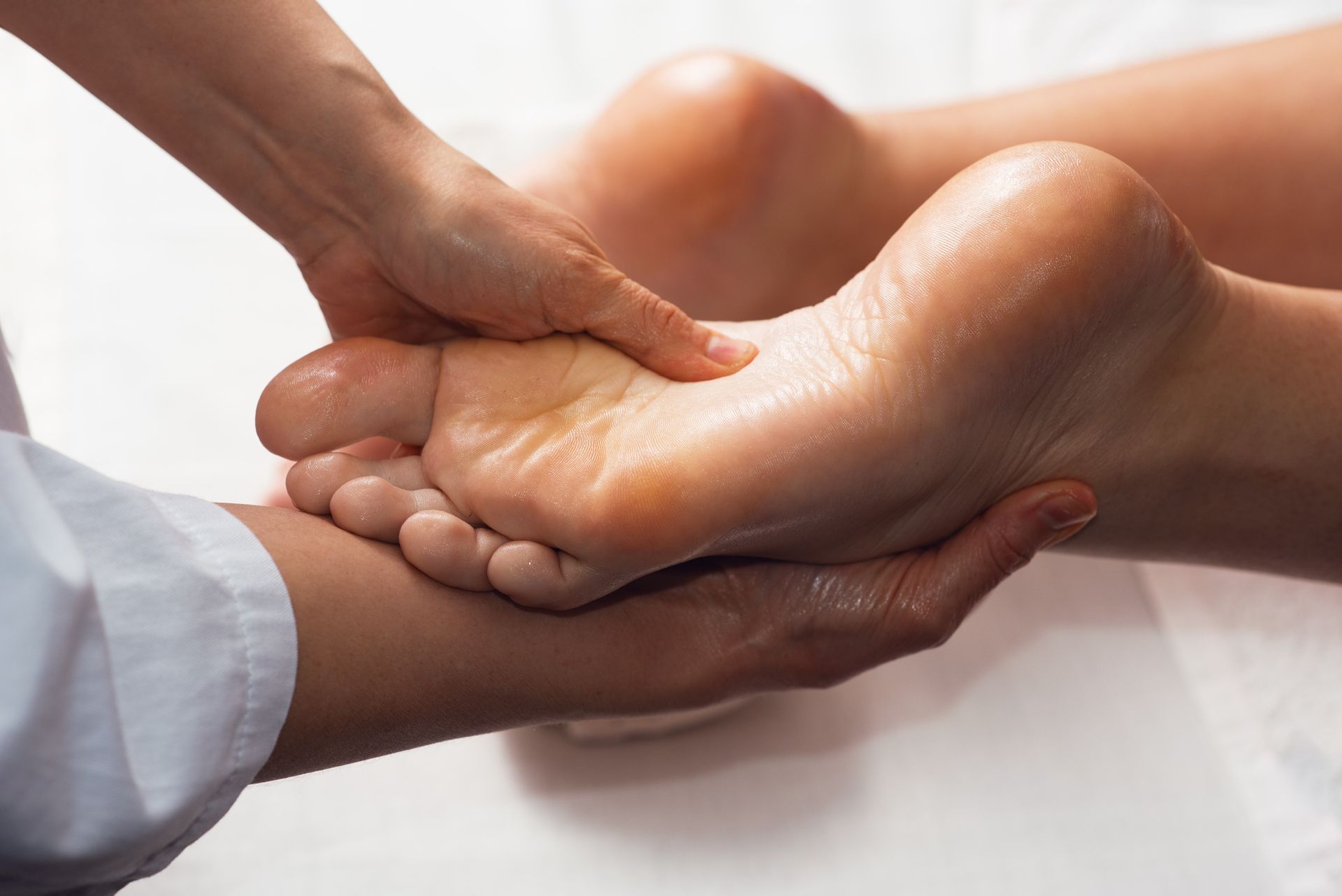 a person is giving a foot massage to another person