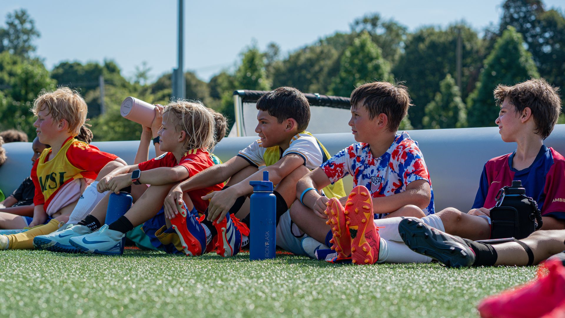 MSI Summer Camp players listening to instructions for the next activity on the inflatable field.