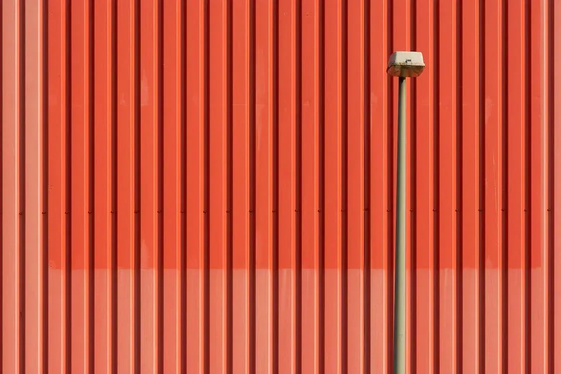 A white roof of a building with a window in the background.