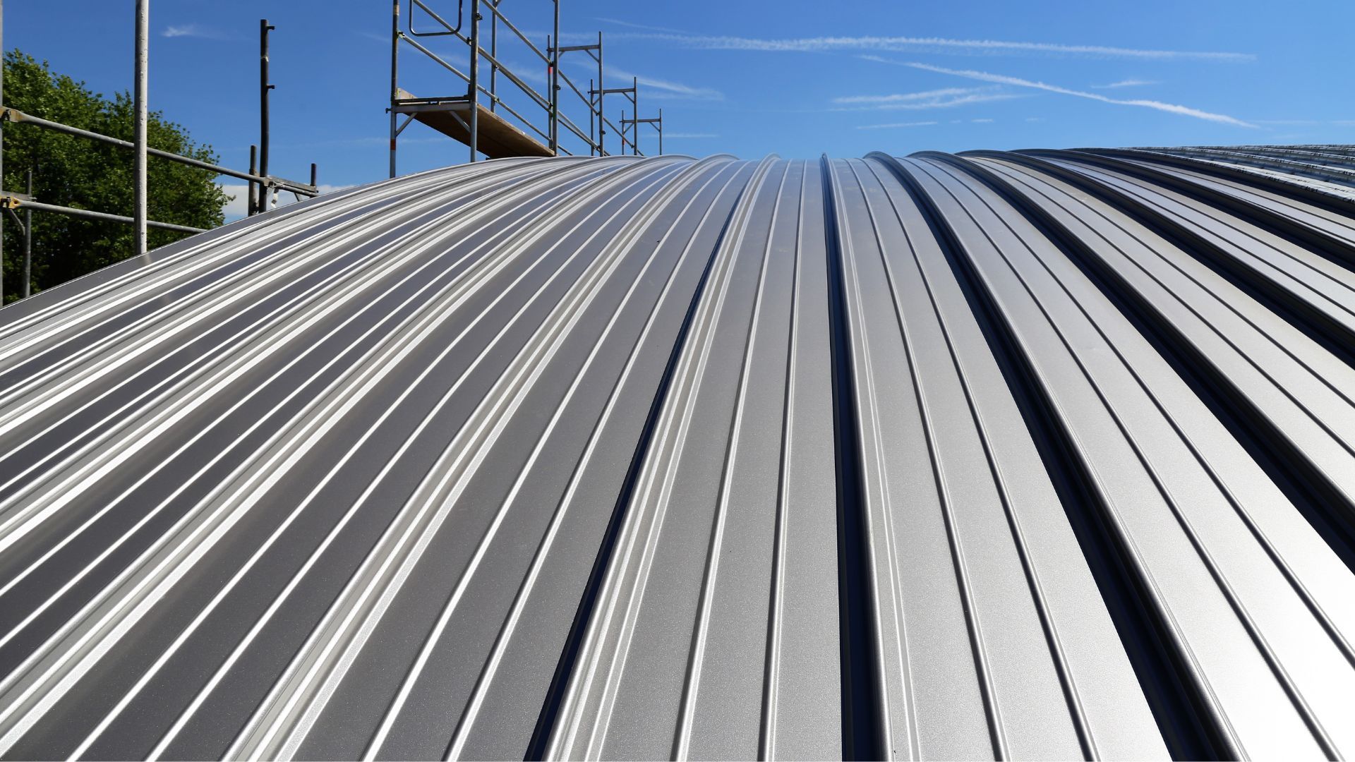 Standing seam metal roof installation, an example of energy-efficient roofing with heat-reflective metal panels.