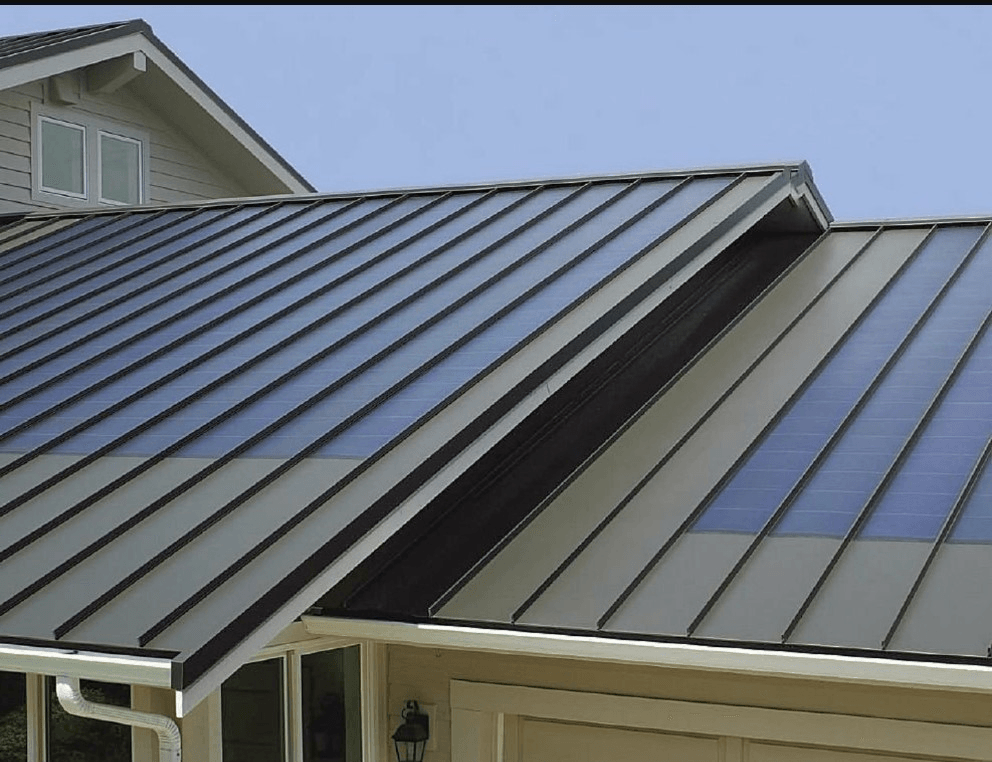 A house roof with dark metal panels, some sections featuring integrated solar energy strips.