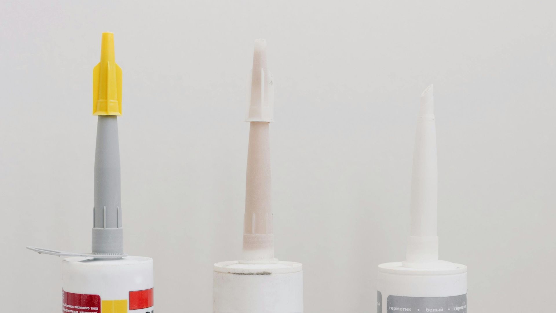 Various sealant cartridges with nozzles.