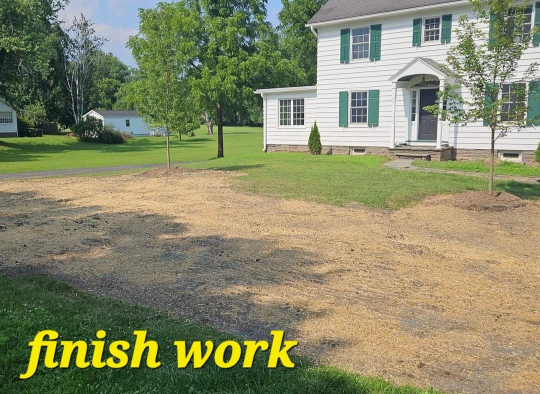 Front yard with bare ground, a white house, and yellow text reading “finish work”