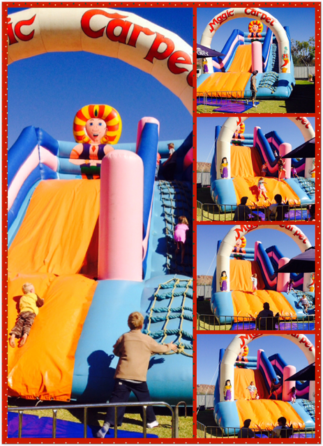 Children climbing and sliding on a large inflatable bounce house with orange, pink, and blue sections, under a sunny sky.