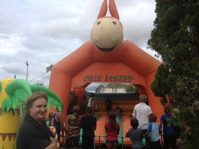 People at an outdoor event with an orange inflatable 