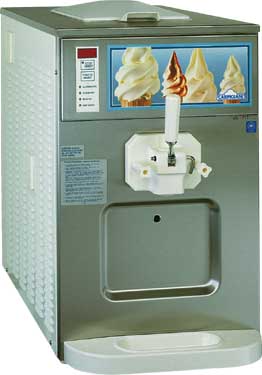 A stainless steel soft-serve ice cream machine with a dispenser and a drip tray. 