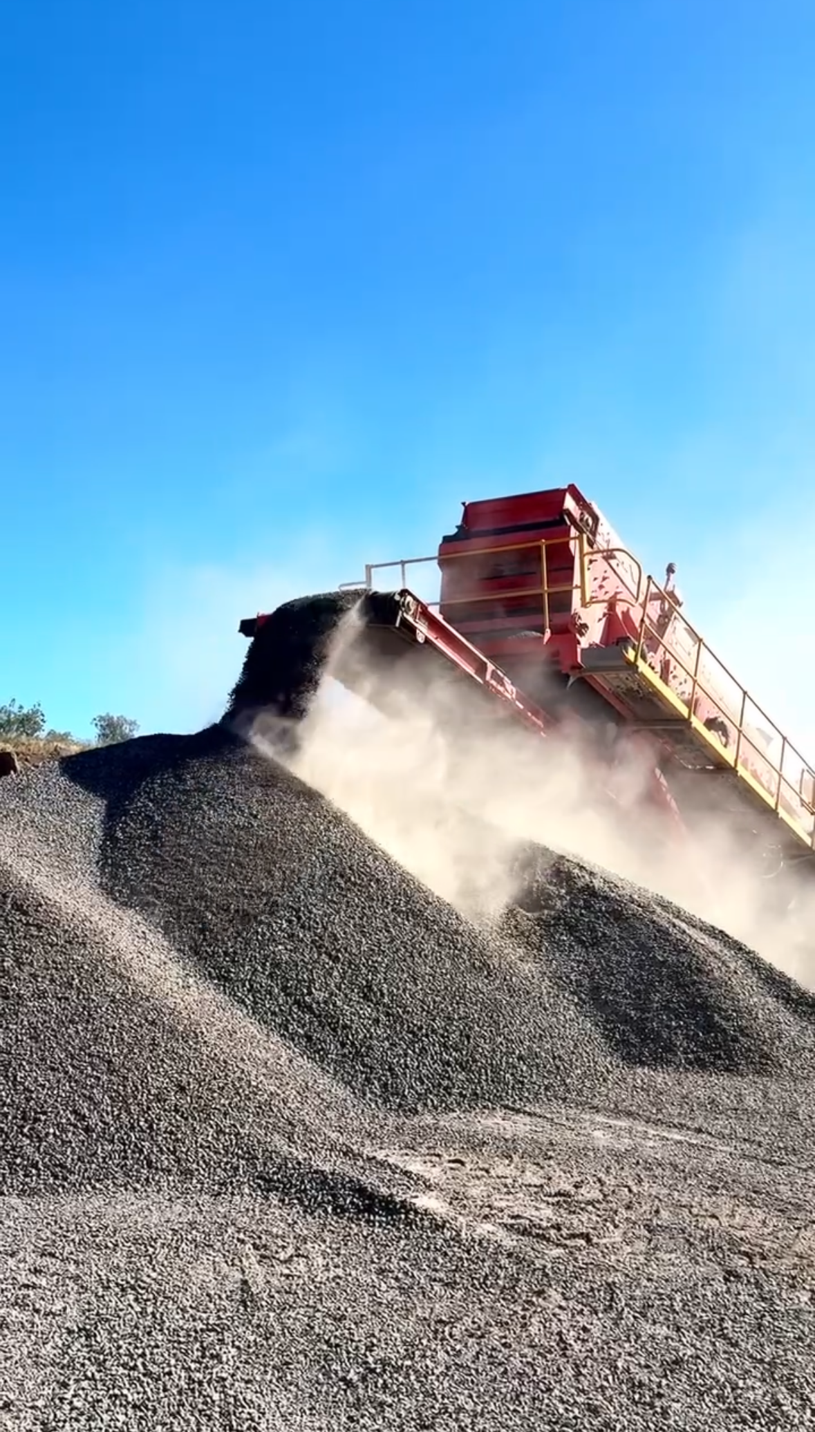 A Rock Crushing Machine in Operation, Depositing Stone — D&S Quarries in Lansdowne, NT