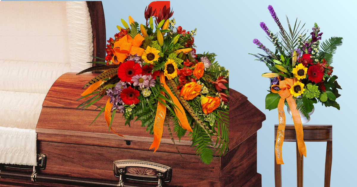 Floral arrangements on a wooden casket and a side table in a funeral setting