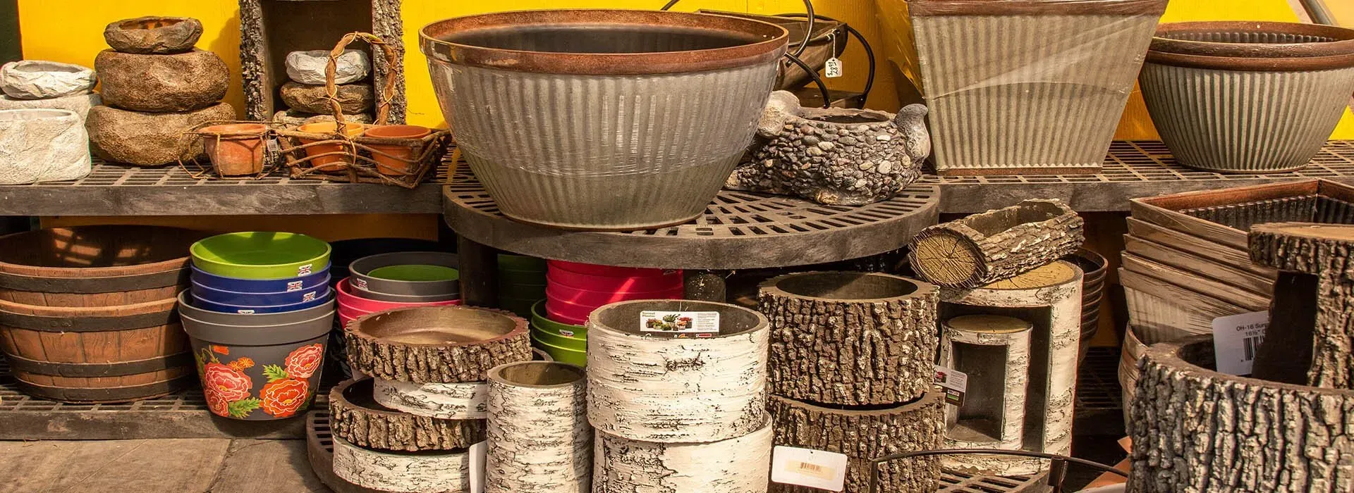 Colorful woven baskets and pottery displayed on shelves in a market stall