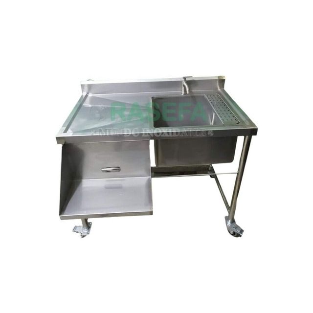 Mesa de cocina de acero inoxidable con tablero de cristal, estante inferior y ruedas.