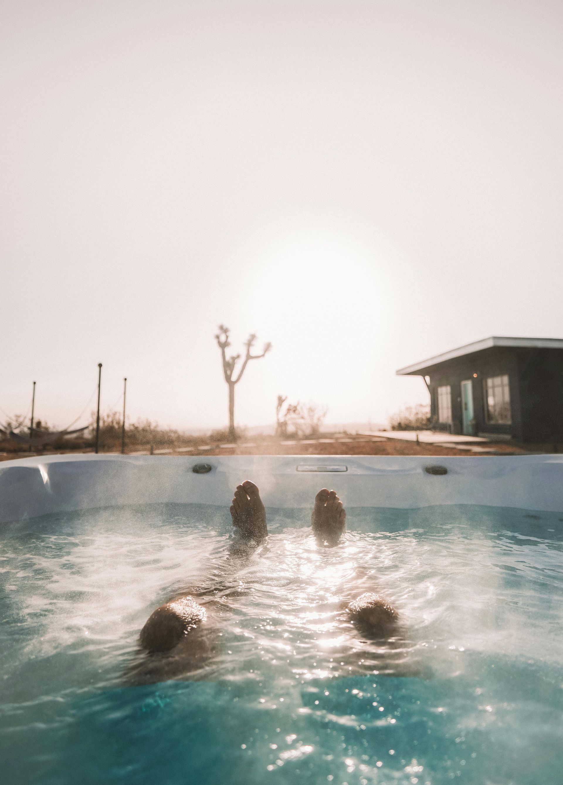 Person enjoying warm hot tub with proper heating and functioning jets