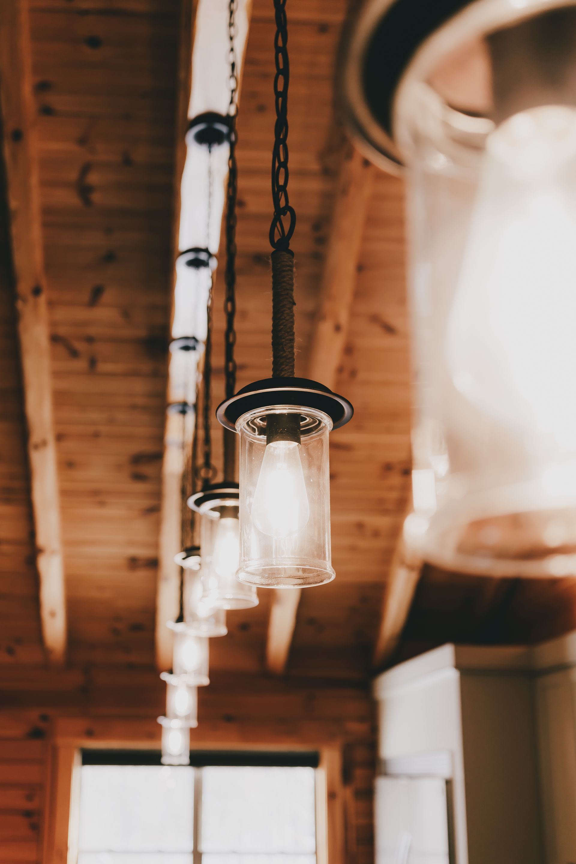 A row of lights hanging from the ceiling in a room.