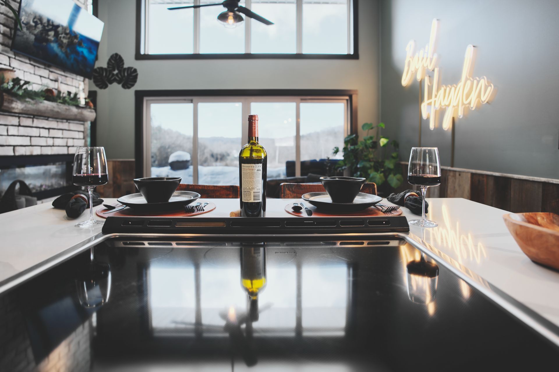 A bottle of wine is sitting on a table in a kitchen.
