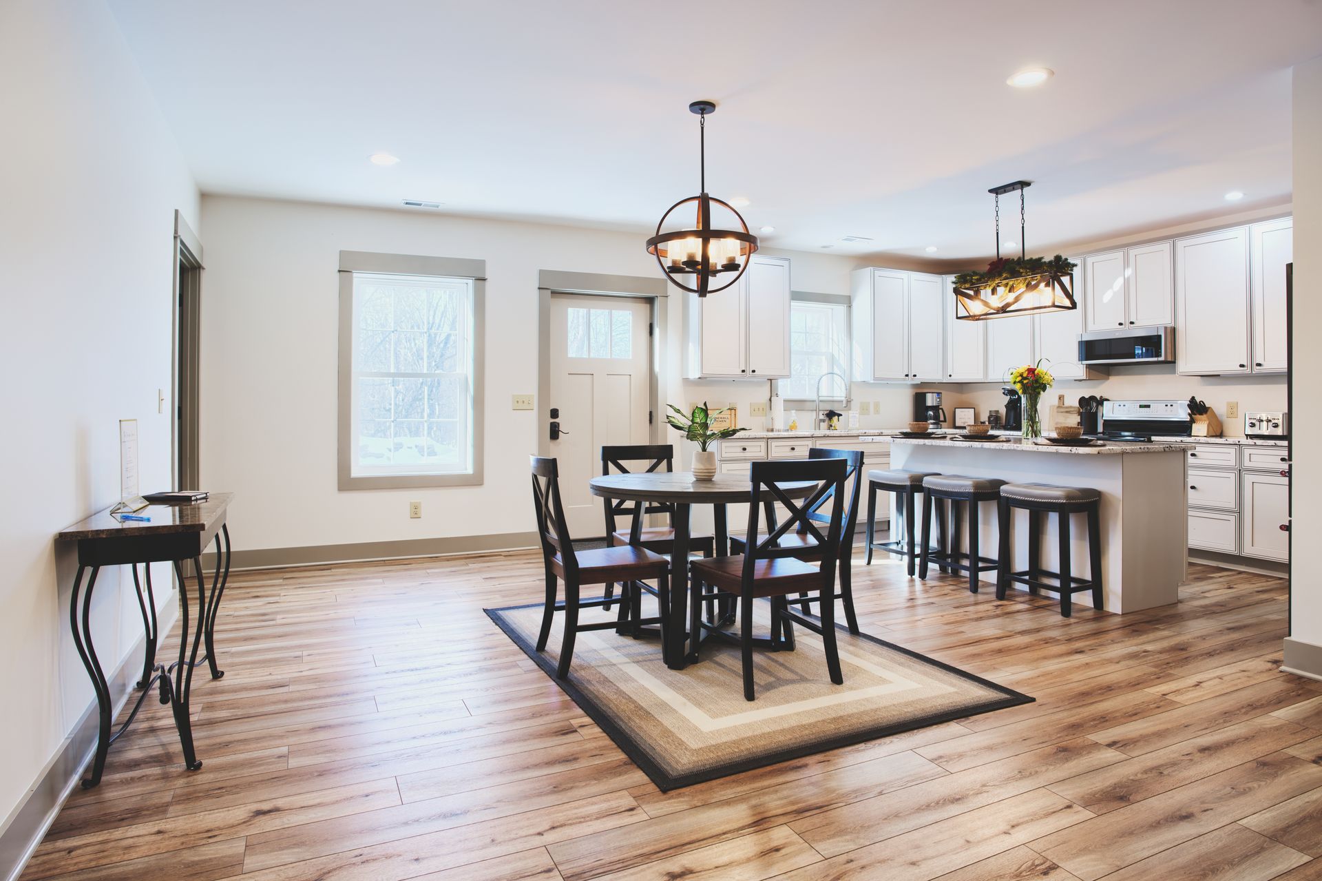 There is a dining room table and chairs in the middle of the room.