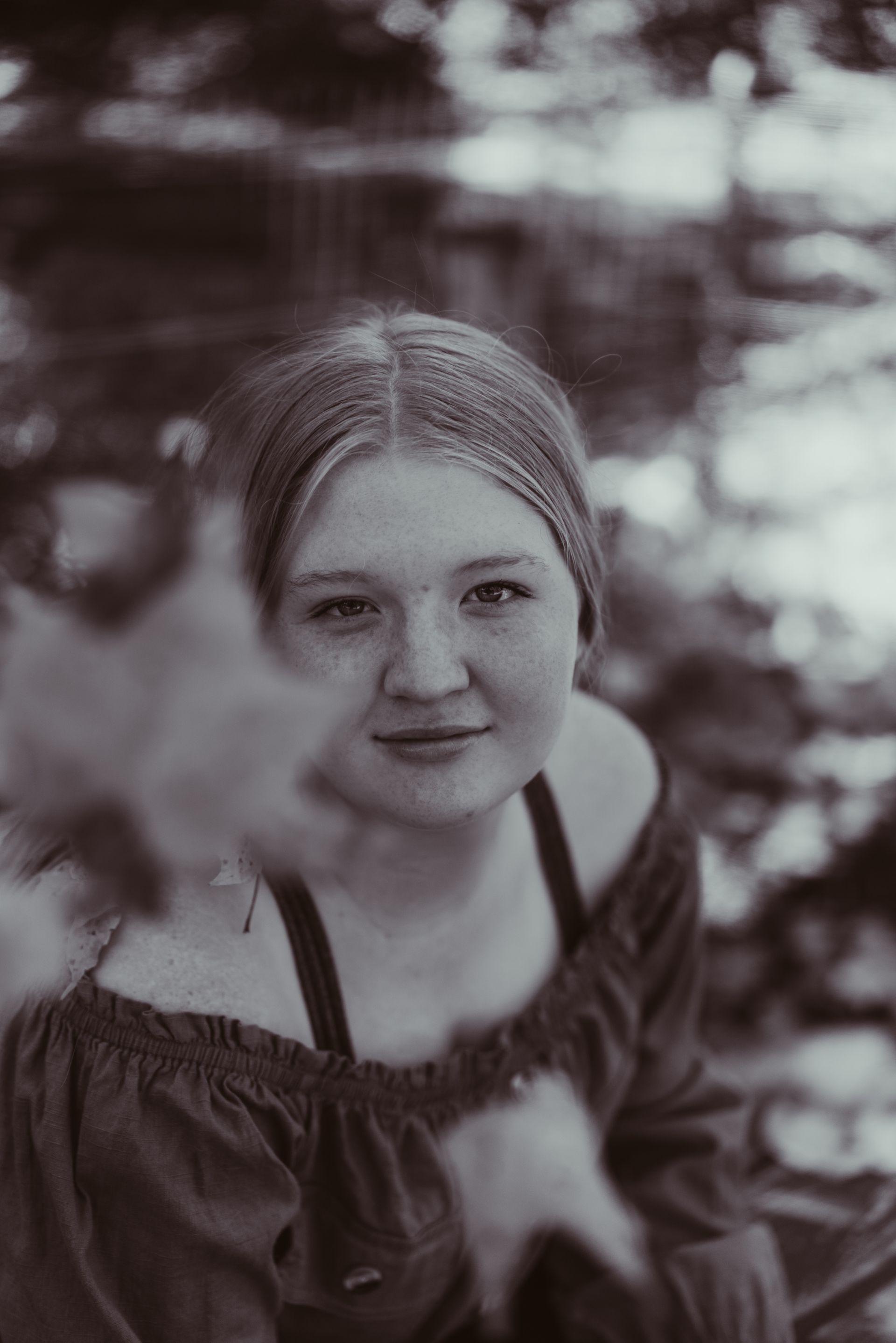 a black and white photo of a senior wearing a headband .