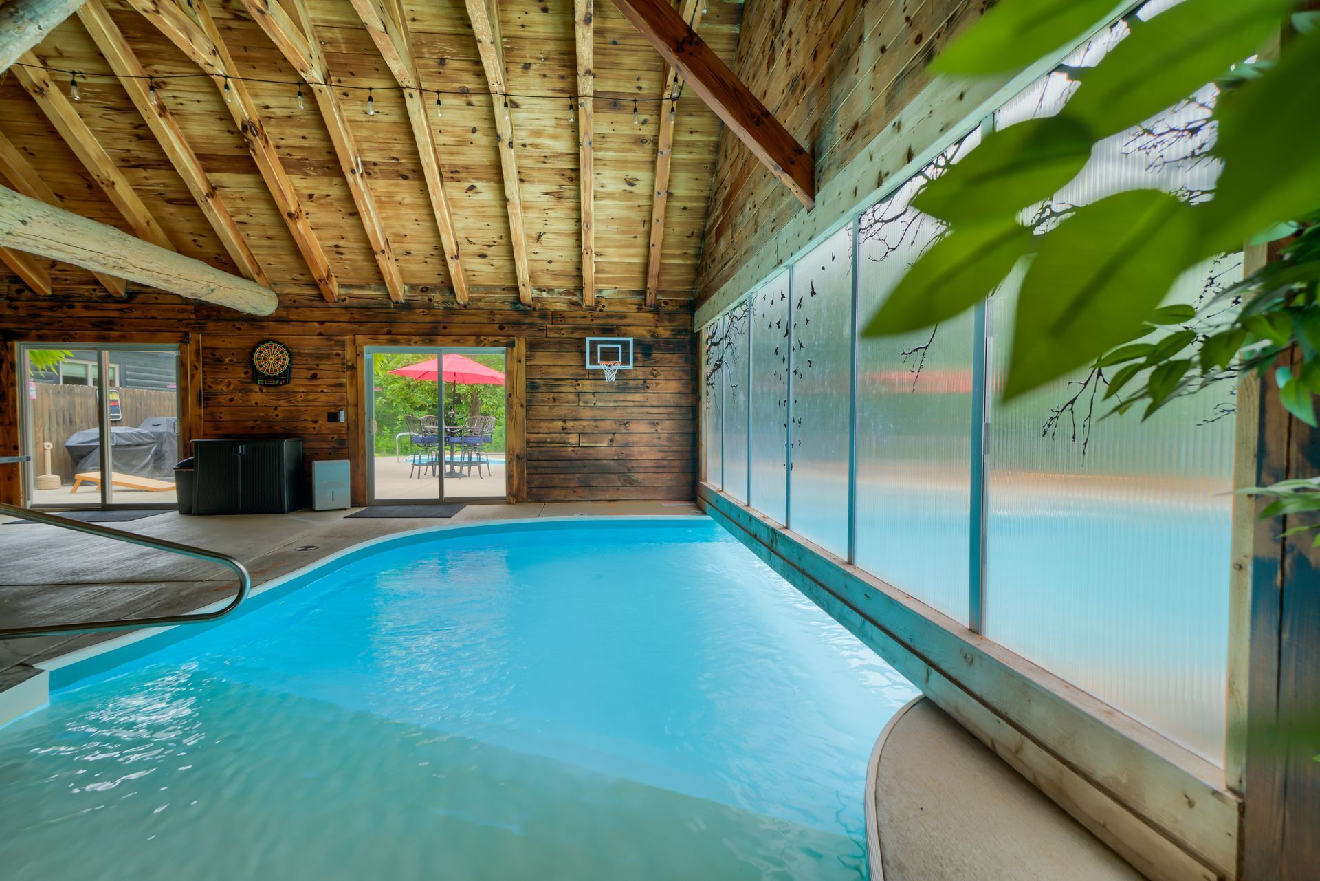 a large indoor swimming pool in a log cabin .