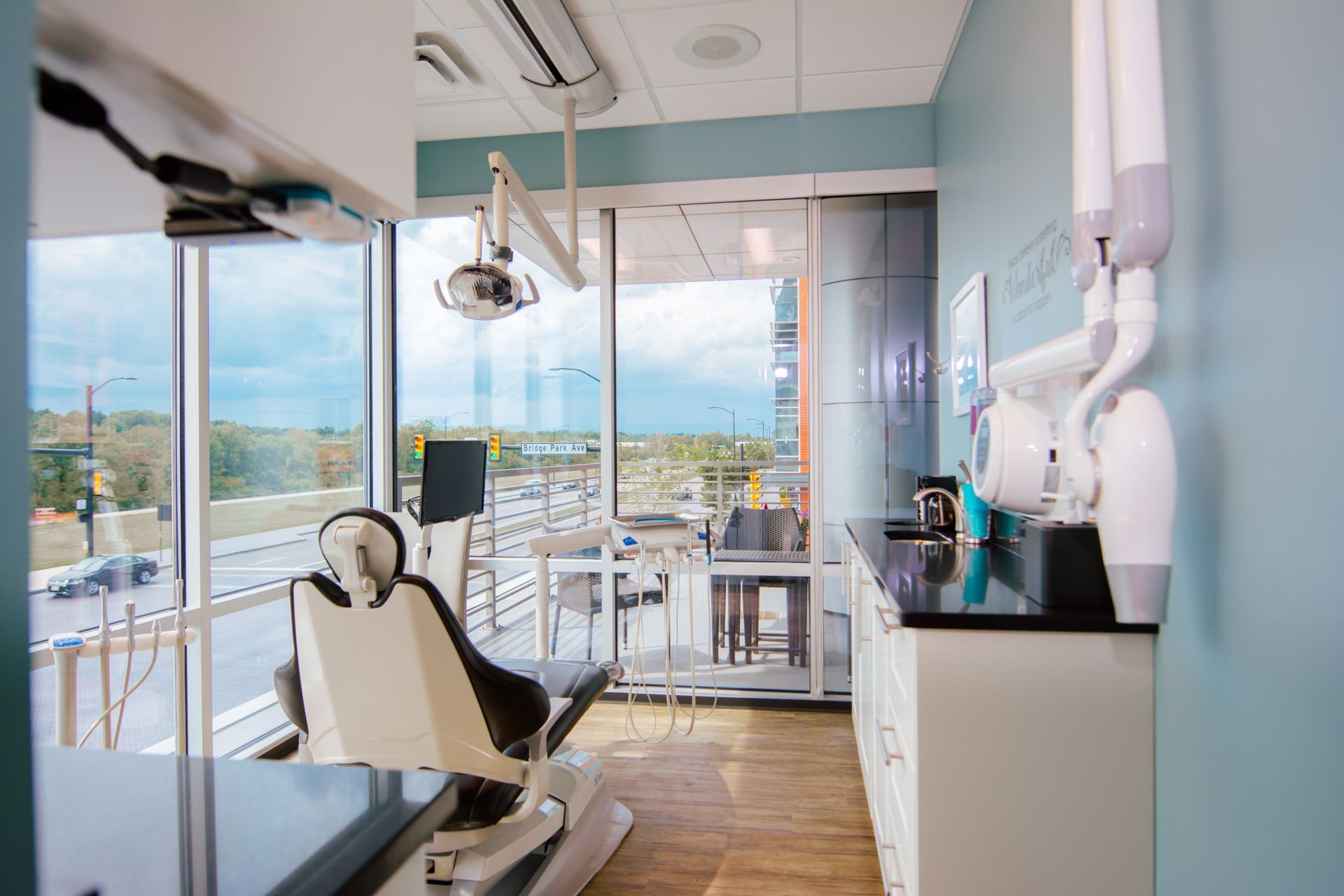 A dental office with a dental chair and a large window.