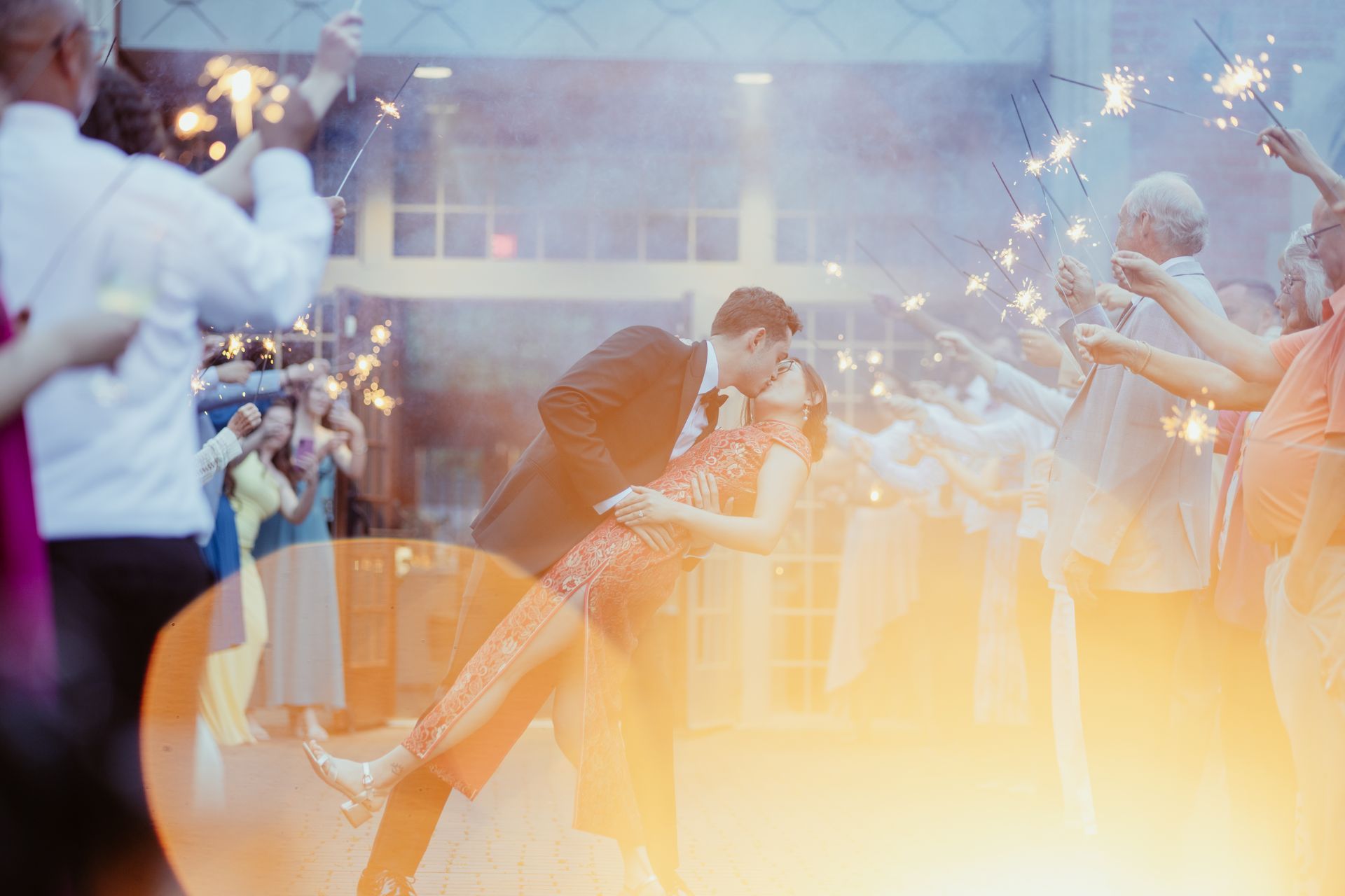 a bride and groom are holding hands with a bouquet of flowers .