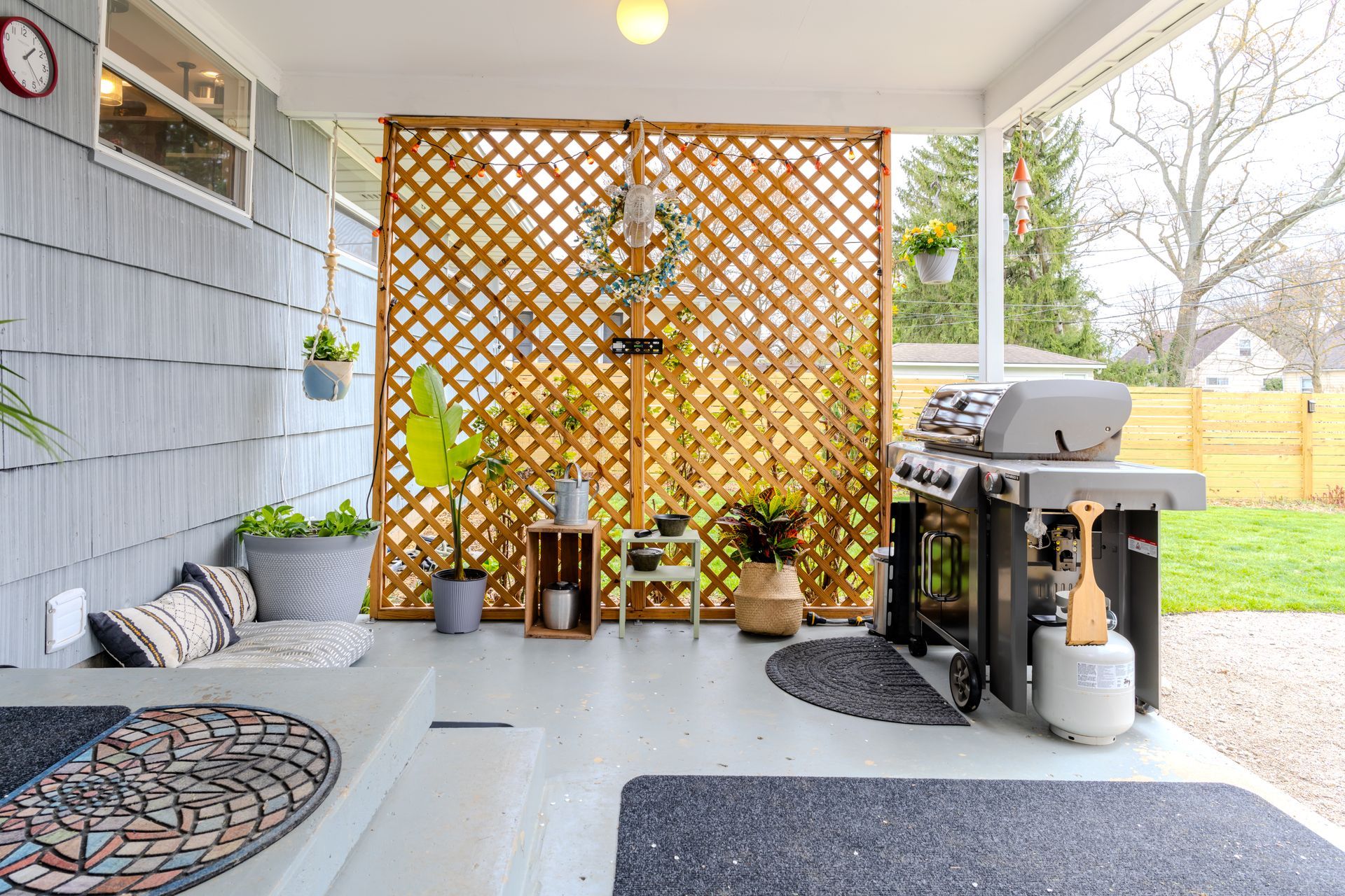 There is a grill on the porch of a house.