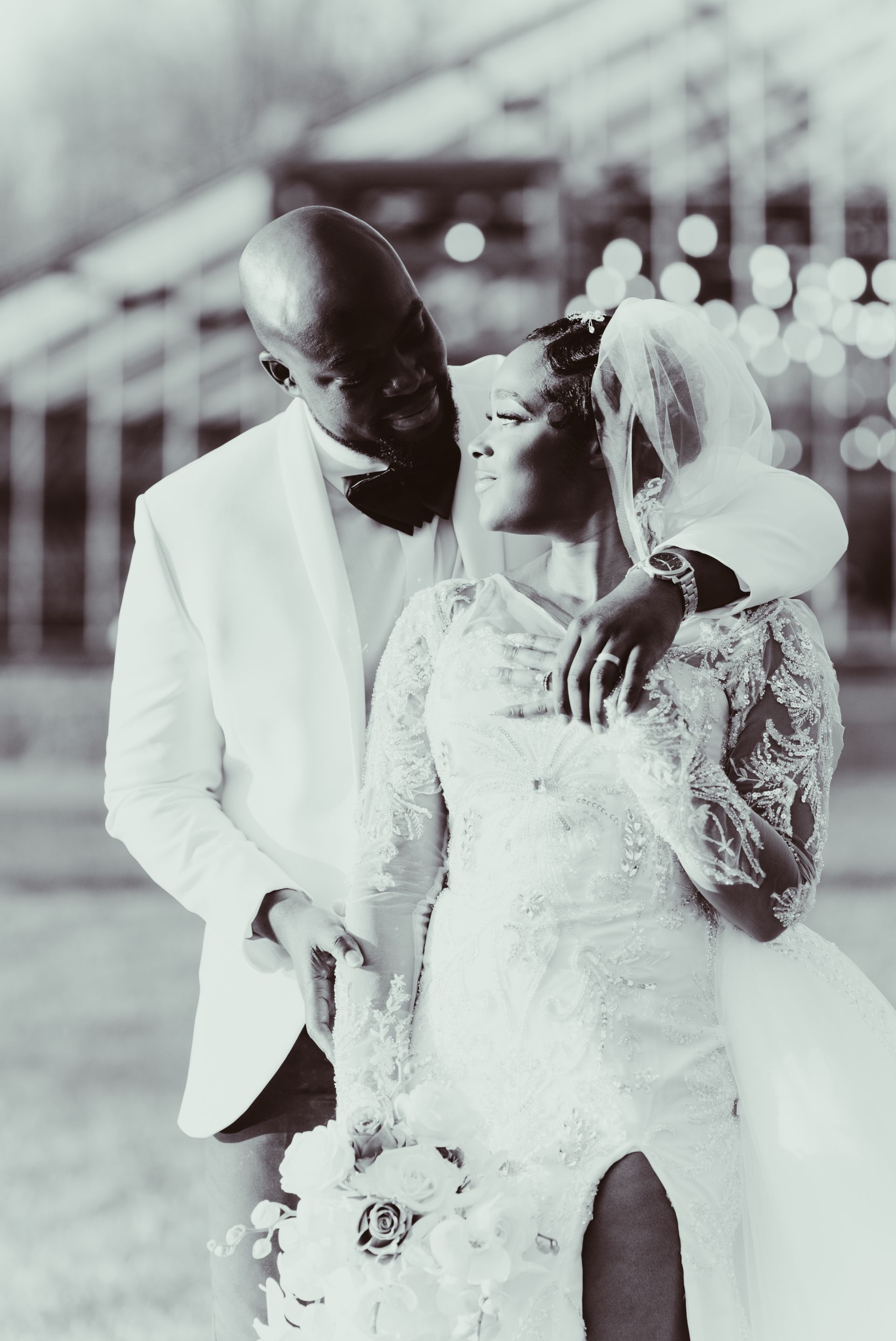 A black and white photo of a bride and groom sunset photo in front of Jorgensen farm oak grove greenhouse