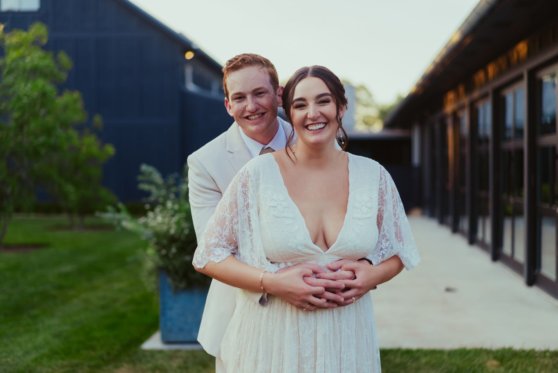 A bride and groom are posing for a picture in front of a building at Jorgensen Oak Grove