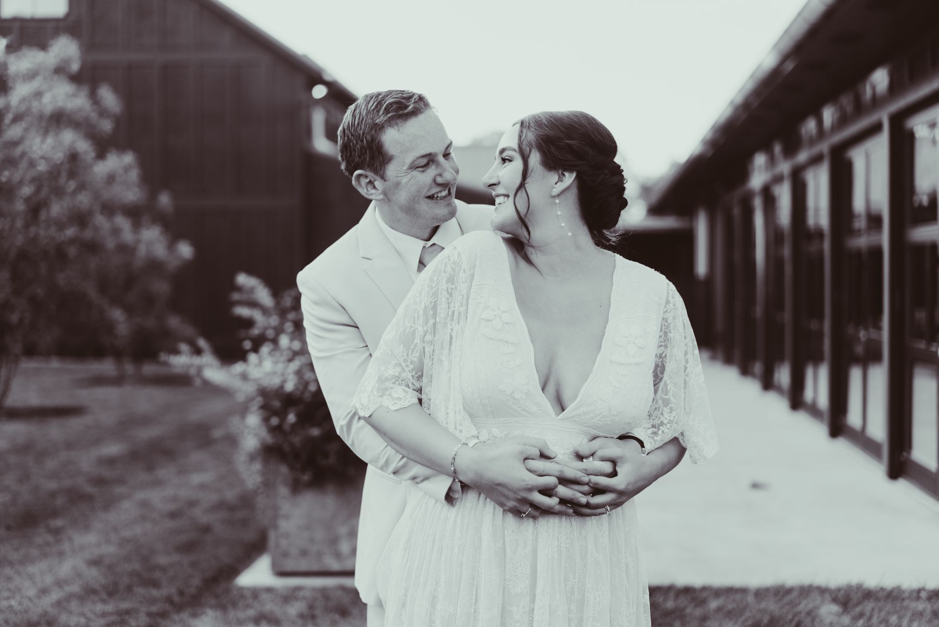 A bride and groom are posing for a black and white photo at Jorgensen Oak Grove