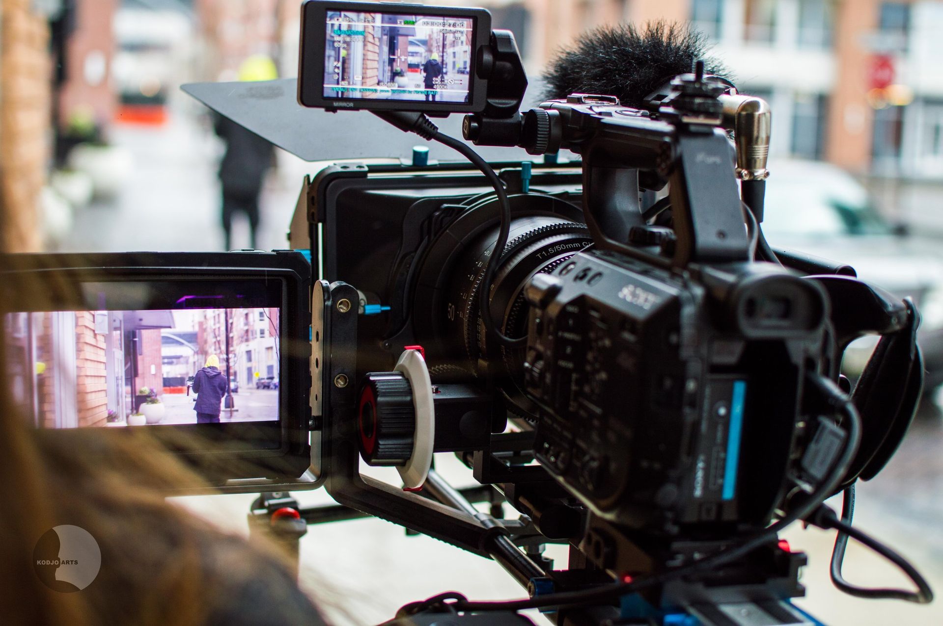a video camera is being used to film a street scene .