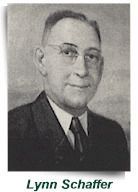 Portrait of Lynn Schaffer in a suit and tie, with his name captioned below