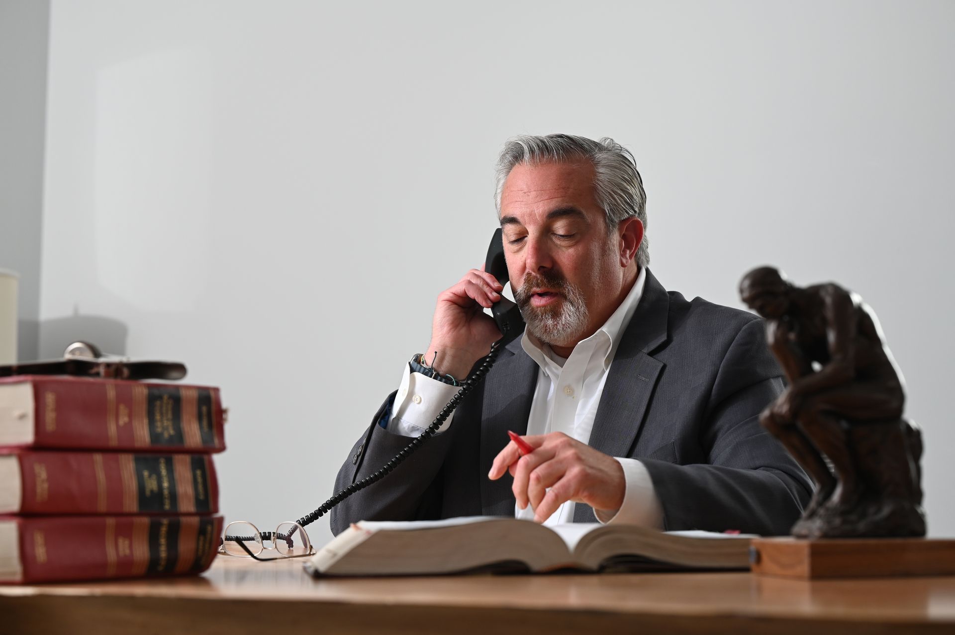 Three lawyers reviewing documents in a bright office meeting room
