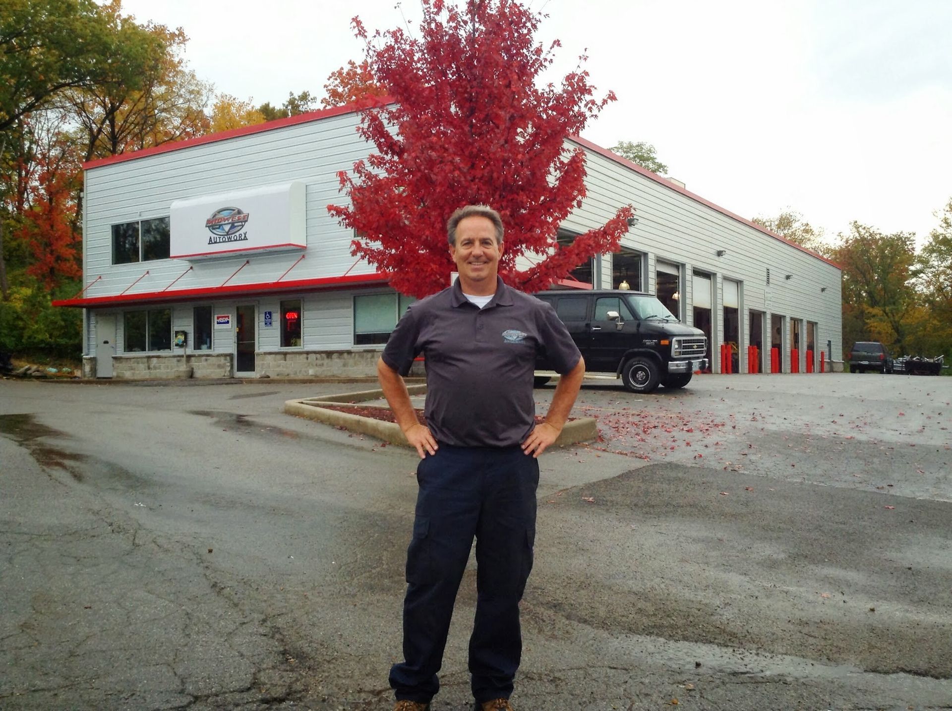 Team Member in Front the Shop | Midwest Autoworx