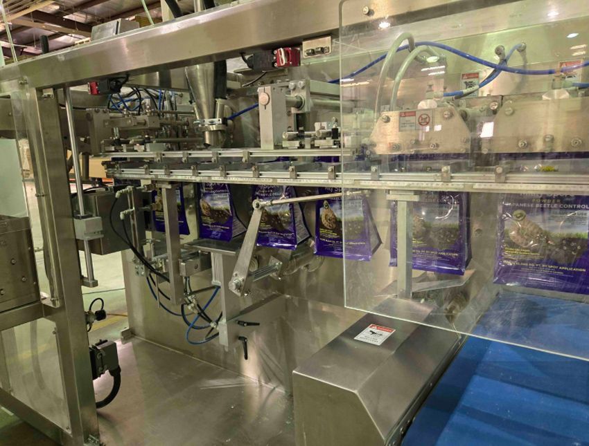 A machine is making bags of food in a factory.