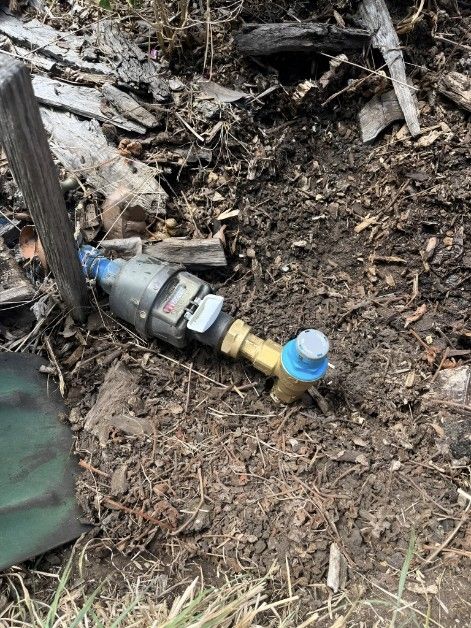 A Water Meter is Laying on the Ground Next to a Shovel — Kerney Plumbing in Bacchus Marsh, VIC